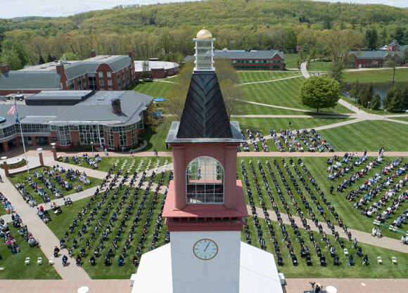 Aerial view of hundreds of grads and guests on the quad during Commencement